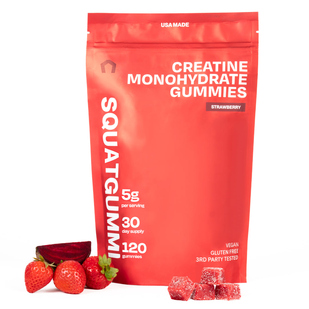 Red package of SquatGummie Creatine Monohydrate Gummies with strawberries and gummies on a white background